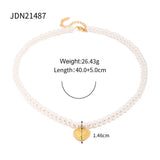 Elegant bridal pearl choker with gold heart charm and gold leaf detailing, displayed against a neutral background to highlight its intricate design and romantic appeal.