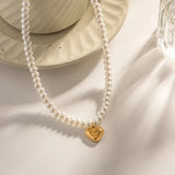 Elegant bridal pearl choker necklace with gold heart charm, perfect romantic gift, featuring white pearls and delicate chain.