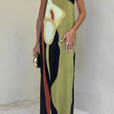 Elegant color block maxi skirt with a sophisticated evening design, featuring a high waistline and flowing silhouette. The model is wearing the skirt paired with a stylish top that has long sleeves and a neckline that complements the overall look.