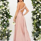 Elegant cream backless evening gown with a bow, suitable for wedding guests, featuring a strapless design and a fitted waist.