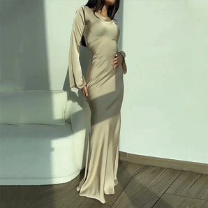 Elegant cream long sleeve maxi dress for women, featuring a formal design with a fitted waist and flowing silhouette, ideal for formal occasions.
