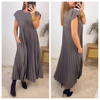 Elegant black sleeveless maxi dress in a flowy summer pleated design, showcasing a one-piece garment with a fitted neckline and armholes, suitable for day wear.