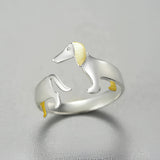 Elegant silver ring with gold accents featuring dog-themed design, perfect for pet lovers.