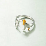 Elegant dog-themed silver ring with gold accents, featuring intricate design elements and a gemstone centerpiece, perfect for pet lovers.