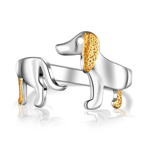 Elegant silver ring with gold accents featuring a detailed dog-themed design, perfect for pet lovers.