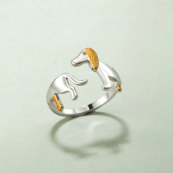 Elegant silver ring featuring dog-themed design with gold accents, perfect for pet lovers, displayed close-up showing intricate details and craftsmanship.
