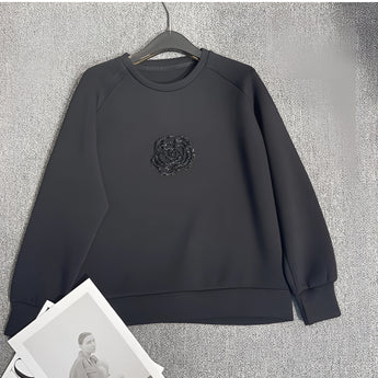 Elegant floral embroidered women's white sweatshirt featuring intricate floral designs on the front, with long sleeves and a classic round collar. The sweatshirt is styled for a fashionable yet comfortable fit, ideal for casual wear.