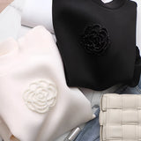 Elegant white women's sweatshirt featuring intricate floral embroidery, displaying long sleeves and a classic round collar.
