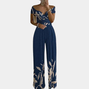 Elegant blue floral off-shoulder denim jumpsuit in women's 3XL, showcasing fashionable design with an emphasis on shoulders, waist, and thighs.