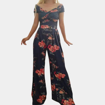 Elegant floral off-shoulder denim jumpsuit in dark blue, showcasing a luxurious women's one-piece garment with a focus on the shoulder and neck area, highlighting the stylish design and textile details.
