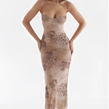 Elegant floral velvet gown featuring a sleeveless design with a criss-cross back detail, showcasing a form-fitting silhouette and a day dress style.