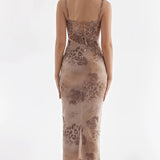 Elegant sleeveless floral velvet gown featuring a sheath silhouette with a criss-cross back design, showcasing a stylish and sophisticated fashion statement.