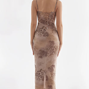 Elegant sleeveless floral velvet gown featuring a sheath silhouette with a criss-cross back design, showcasing a stylish and sophisticated fashion statement.