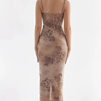 Elegant sleeveless floral velvet gown featuring a sheath silhouette with a criss-cross back design, showcasing a stylish and sophisticated fashion statement.