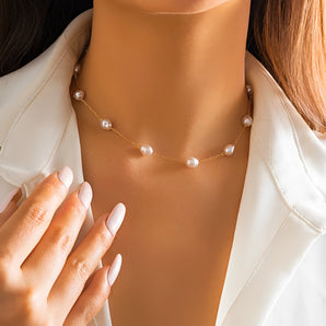 Gold chain pearl necklace draped elegantly around the neck, ideal for bridal wear and gifting, highlighting the delicate clasp and intricate design.