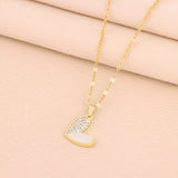 Elegant gold chain necklace with a white enamel heart-shaped pendant adorned with rhinestones.