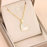 Elegant gold chain necklace with a white enamel heart-shaped pendant adorned with rhinestones.