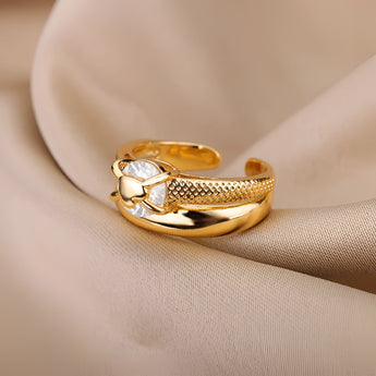 Elegant gold floral engagement ring with unique diamond twist band, featuring intricate floral designs and a sparkling diamond centerpiece.