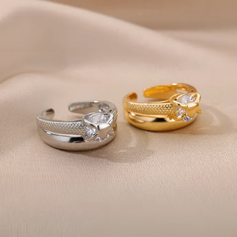 Elegant gold floral engagement ring with unique diamond twist band, featuring intricate floral design and sparkling gemstones.