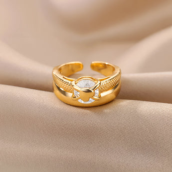 Elegant gold floral engagement ring featuring a unique diamond twist band.