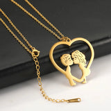 A pair of hands holding an elegant gold heart-shaped couple necklace, ideal as a romantic anniversary gift.