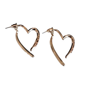 Elegant gold heart-shaped earrings in 14K gold, luxury women's statement jewelry.