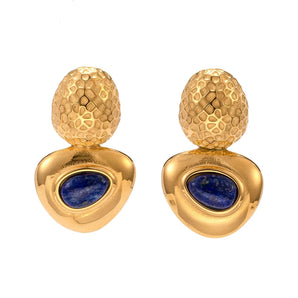 Elegant gold lapis lazuli drop earrings on a wooden surface, showcasing designer luxury jewelry.