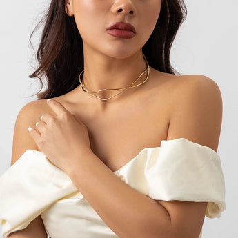 Close-up of a woman wearing an elegant gold layered choker featuring a sleek minimalist double band design.