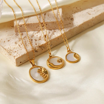 Elegant gold necklace with a mother of pearl sunburst pendant, featuring a Hamsa and celestial charm.