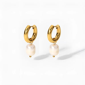 Elegant gold hoop earrings adorned with pearls, showcasing luxury women's designer jewelry.