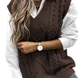 A stylish coffee-colored XXL men's sleeveless wool sweater vest featuring an elegant gray cable knit pattern, paired with a black and white outfit. The model is accessorized with a watch and sunglasses, showcasing a modern fashion look.