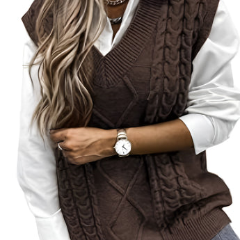 A stylish coffee-colored XXL men's sleeveless wool sweater vest featuring an elegant gray cable knit pattern, paired with a black and white outfit. The model is accessorized with a watch and sunglasses, showcasing a modern fashion look.