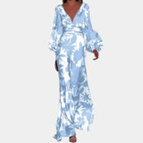 Elegant green palm leaf satin V-neck maxi dress with a flowing silhouette, featuring a vibrant leaf print on a soft, luxurious fabric. The dress showcases a flattering V-neckline, long sleeves, and a fitted waist, exemplifying sophisticated fashion design for a plus-size figure.