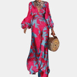Elegant green palm leaf satin V-neck maxi dress with long sleeves, featuring a fitted waist and a flowing skirt, ideal for day wear and special occasions.