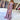 
A woman wearing an elegant lavender lace gown with a sweetheart neckline and high slit, styled in the Viola color and size XL. The dress features intricate lace detailing and is designed with a fitted waist and cap sleeves, perfect for a bridal party or formal event.