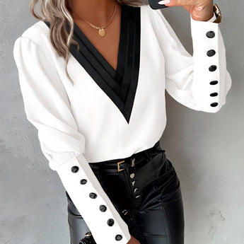 
A women's elegant white blouse featuring buttoned sleeves, designed in a dress shirt style, suitable for formal or casual occasions.