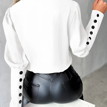 Elegant light pink blouse with buttoned sleeves for women, featuring a dress shirt style and tailored fit, highlighting shoulder and neck areas, displayed against a white background.