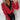 A woman wearing a red long-sleeve blouse with button details, featuring a collar and tailored fit, suitable for an elegant look.