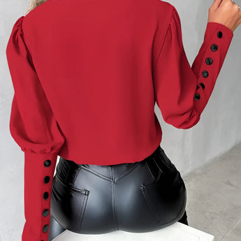 Elegant light pink blouse for women featuring button detail on the sleeves, white accents, and stylish design with focus on shoulder and waist areas.