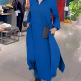 Elegant long black maxi dress with high collar and pockets displayed on a mannequin, featuring a flowing silhouette and stylish sleeves, perfect for formal occasions.