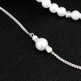 Elegant long pearl bridal back-drop necklace with silver chain, perfect for wedding jewelry and fashion accessory.