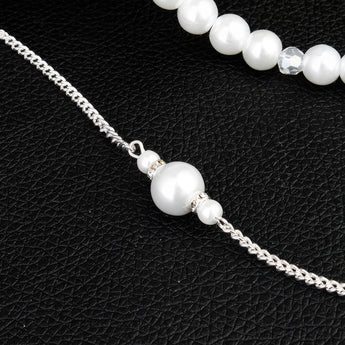 Elegant long pearl bridal back-drop necklace with silver chain, perfect for wedding jewelry and fashion accessory.