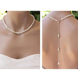 Elegant long pearl back-drop necklace adorning a bride's neck, complementing her wedding dress.