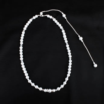 Elegant long pearl bridal back-drop necklace with silver accents, designed for weddings and special events, displayed on a white background.
