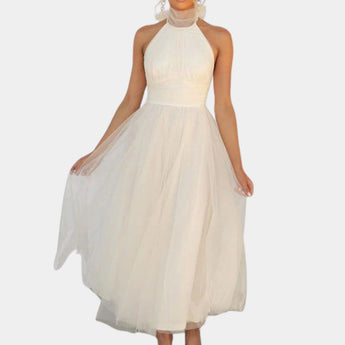 Elegant long women's dress with a halter neck and sleeveless design, featuring a flowy gown style suitable for formal occasions.