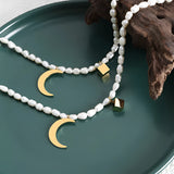 Elegant minimalist pearl choker featuring a gold moon pendant, showcasing luxurious jewelry design with natural materials.