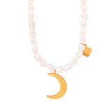 Elegant minimalist pearl choker necklace featuring a gold moon pendant, showcasing luxurious jewelry design.