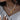 A woman's neck adorned with an elegant minimalist pearl choker featuring a gold moon pendant.
