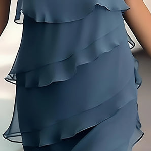Elegant navy blue tiered ruffle dress with lightweight, flowy fabric, featuring layers of ruffles cascading down, showcasing a feminine silhouette with attention to shoulder, waist, and leg areas. Ideal for summer outings.