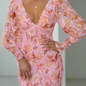 Elegant pink floral maxi dress with long sleeves, featuring a fitted waist and a flowing silhouette, perfect for autumn evenings.
